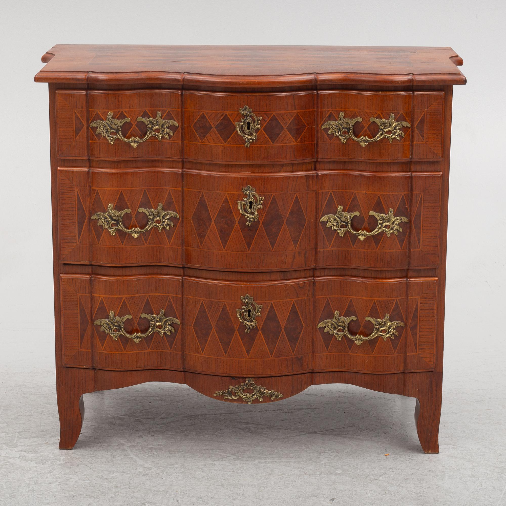 A Baroque style chest of drawers, circa 1900.