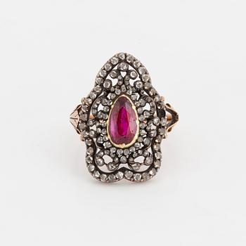 A ring set with a pear-shaped, synthetic ruby and rose-cut diamonds.