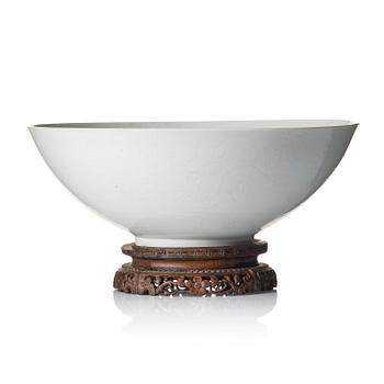 943. A large white glazed anhua decorated five clawed dragon bowl, Qing dynasty, Yongzheng mark and of the period (1723-35).