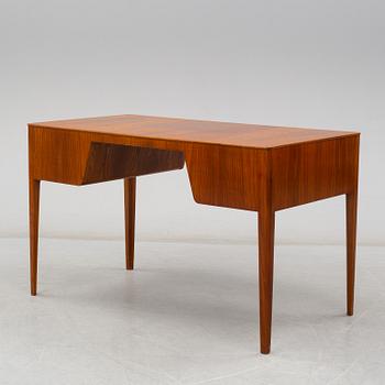 A mid 20th century elm veneered desk.