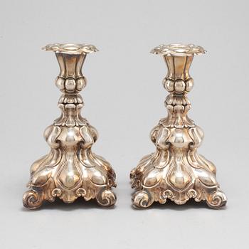 A pair of silver candle sticks.-.