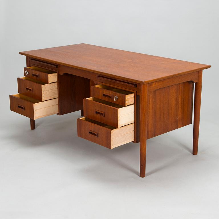 A wooden mid 20th century desk.