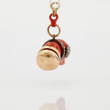 A 14 K gold and silver pendant with carved coral set with rose-cut diamonds.