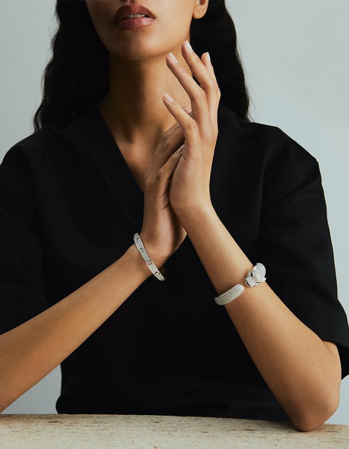 A Cartier Panthère bracelet in 18K white gold set with round brilliant-cut diamonds, emeralds and onyx and a Cartier "Love" bracelet in 18K white gold set with round brilliant-cut diamonds