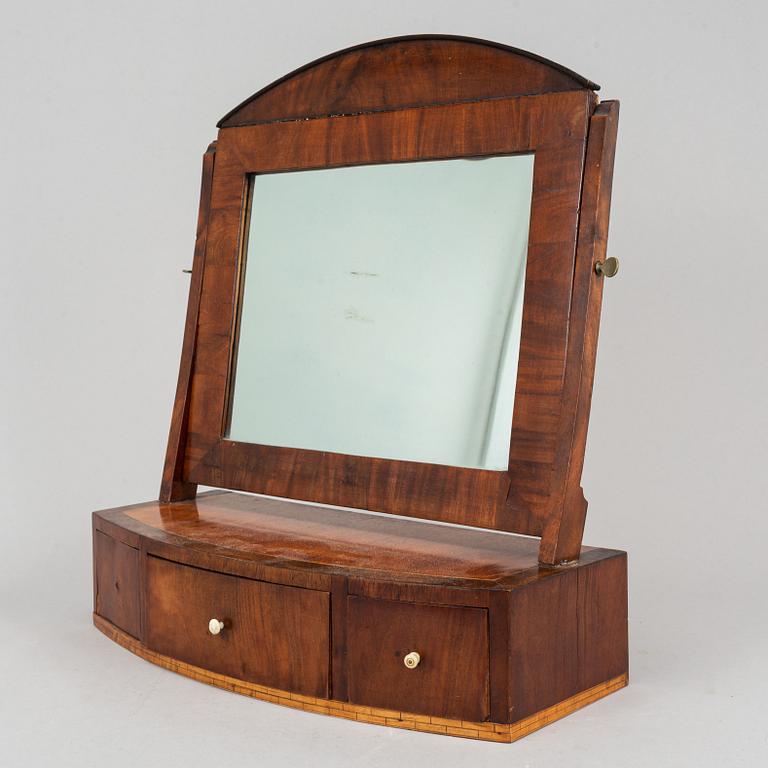 A Swedish Empire mirror with drawer, first half of the 19th century.