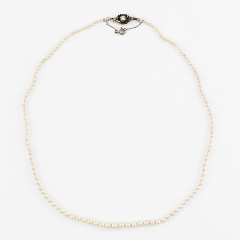 Pearl necklace with graduated cultured pearls, clasp in silver set with pastes, and a pair of pearl earrings,.