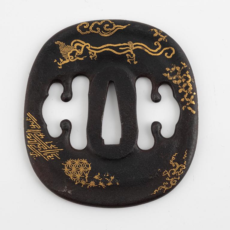 An iron part gilt Japanese tsuba, Edo (1603-1868). In a kiri box.