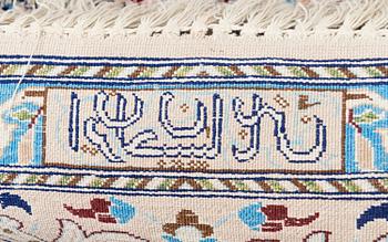 A oriental signed Nain silk carpet. Circa 267x163 cm.