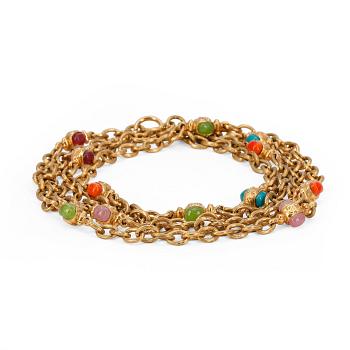565. CHANEL, a gold colored long necklace white multicolored glass stones.