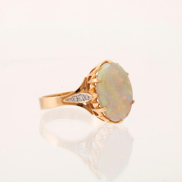 Ring 14K rött och vitt guld med ovalslipad opal samt runda briljantslipade diamanter.