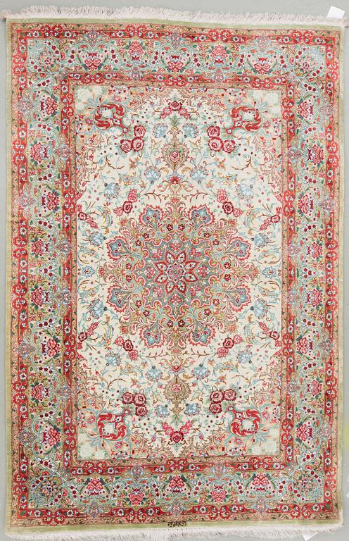 An oriental silk rug, possibly Qum, around 141 x 100 cm.