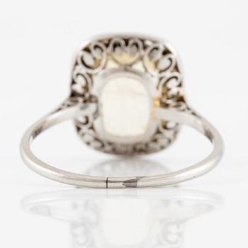 A ring in 18K white gold set with a yellow faceted tourmaline and rose-cut diamonds.