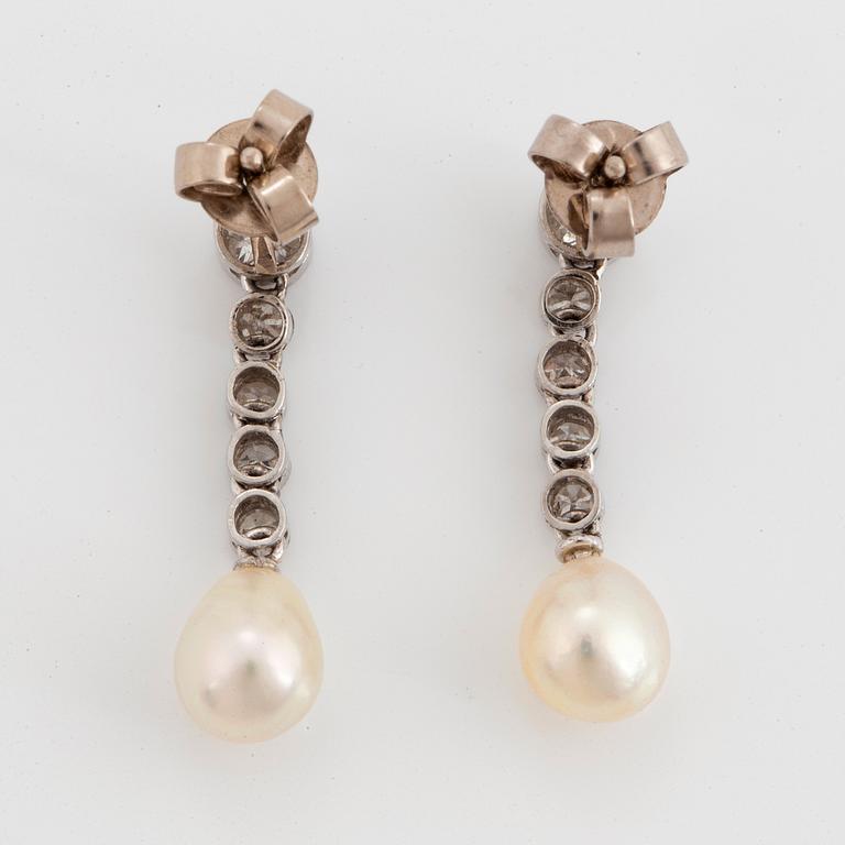 A pair of platinum and 18K white gold earrings set with pearls and old- and eight-cut diamonds.