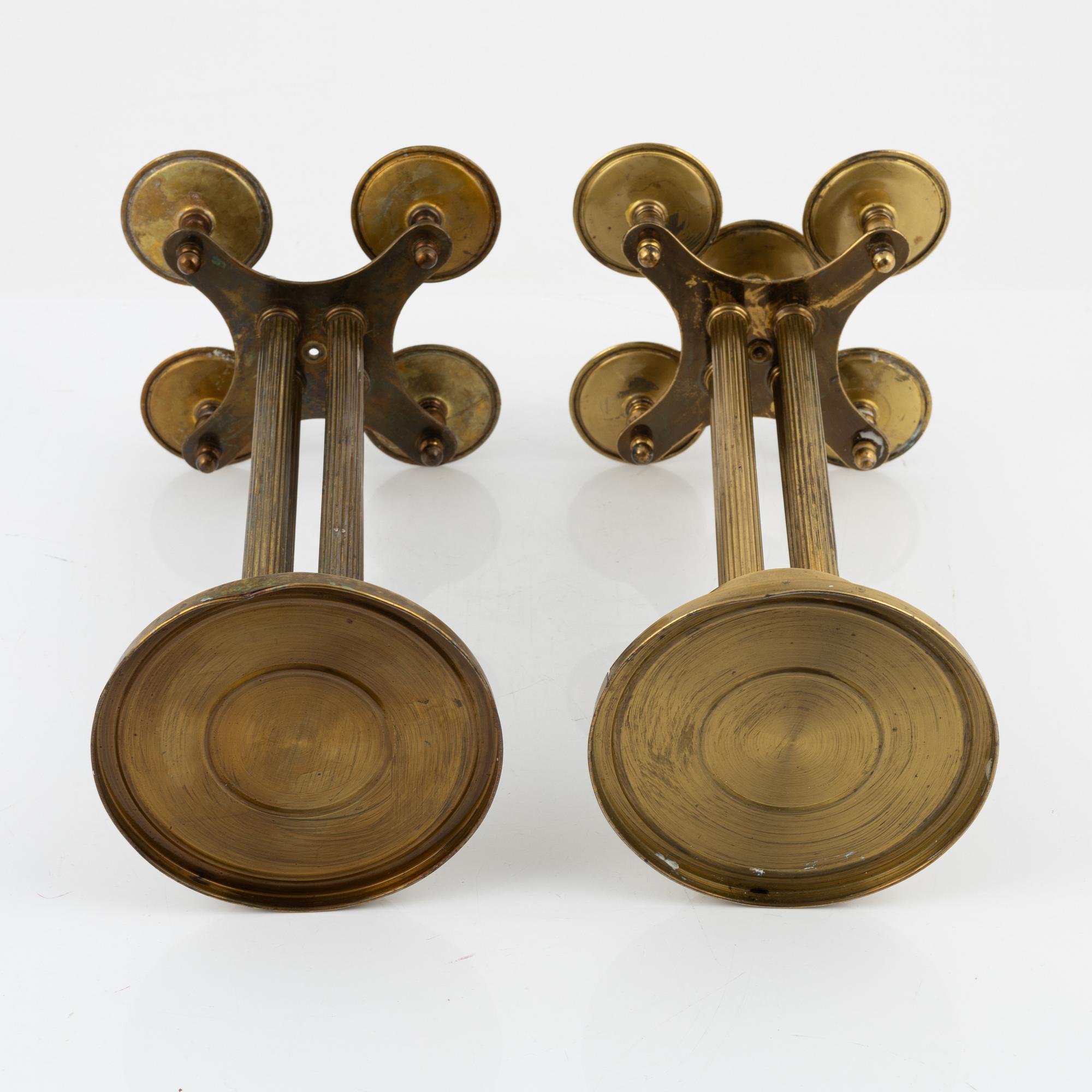 A pair of brass candelabras, first half of the 20th century.