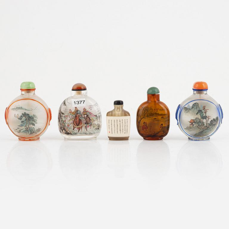 A group of five Chinese snuff bottles with stoppers, "20th Century.