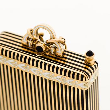 A Cartier Art Deco Vanity Case/Minaudière in 18K gold, black enamel and onyx.