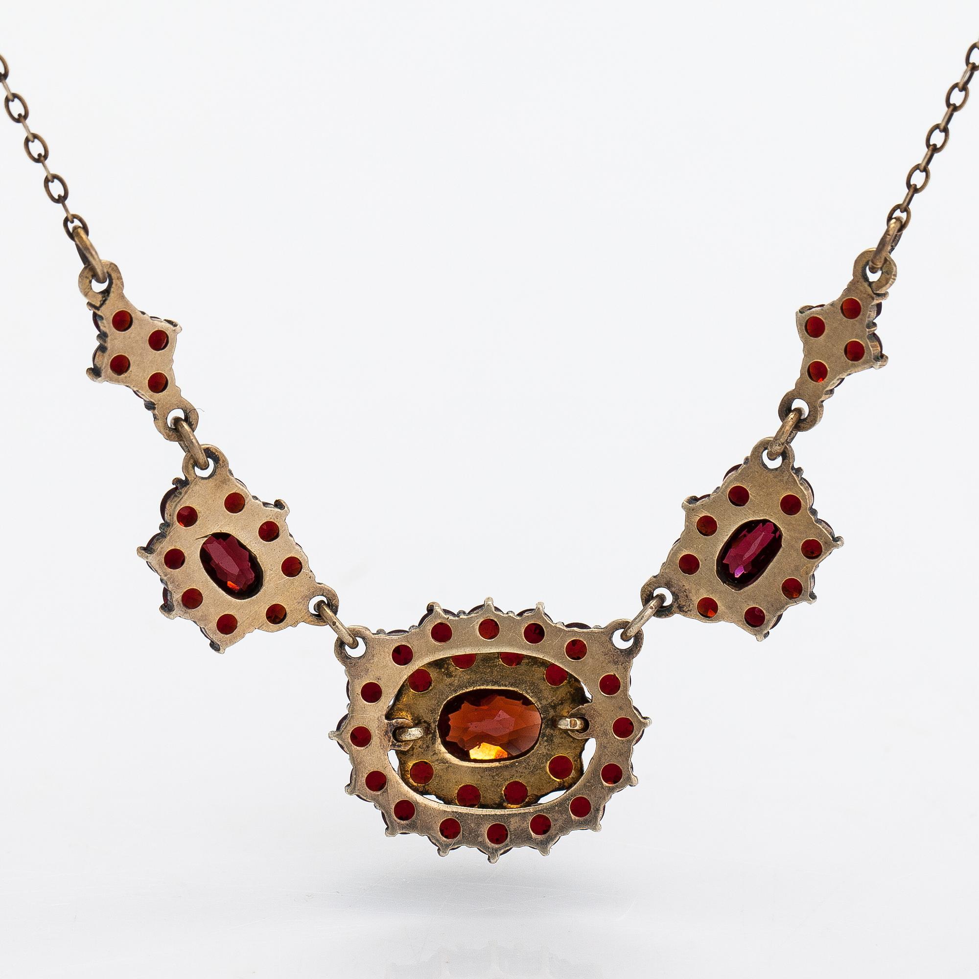 A necklace, brooch and earrings, gilded silver and garnets.