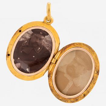 A 14K gold and rose gold locket with monogram MH in relief.