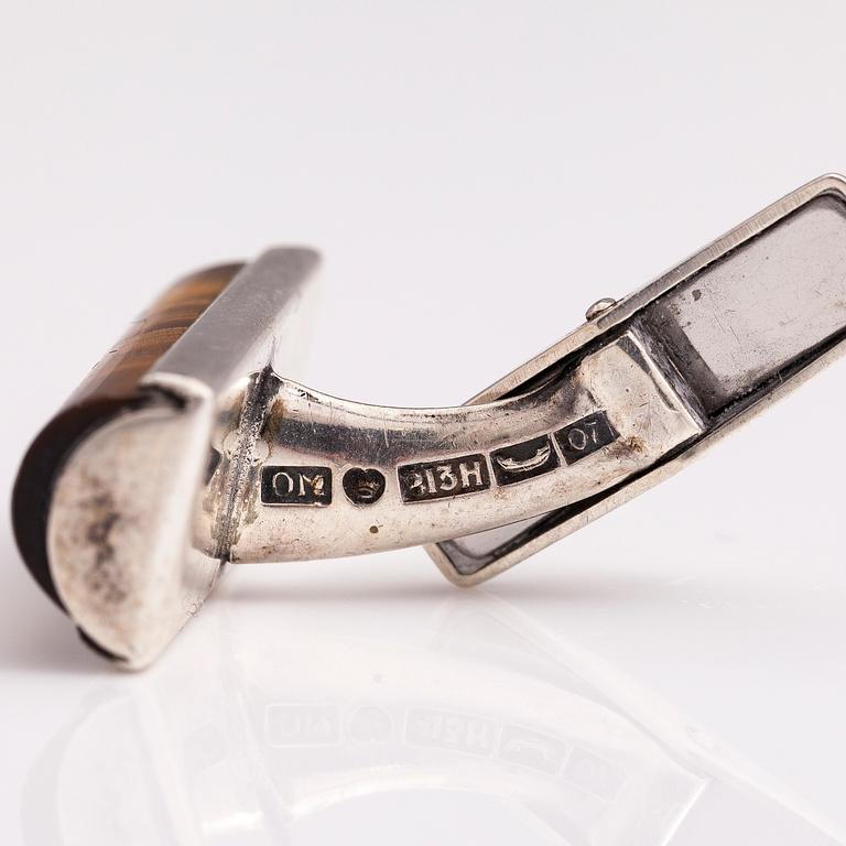 A set of three pairs of silver cufflinks with hematite, tigers eye and granite. Turun Hopea and Osvald Mättö.