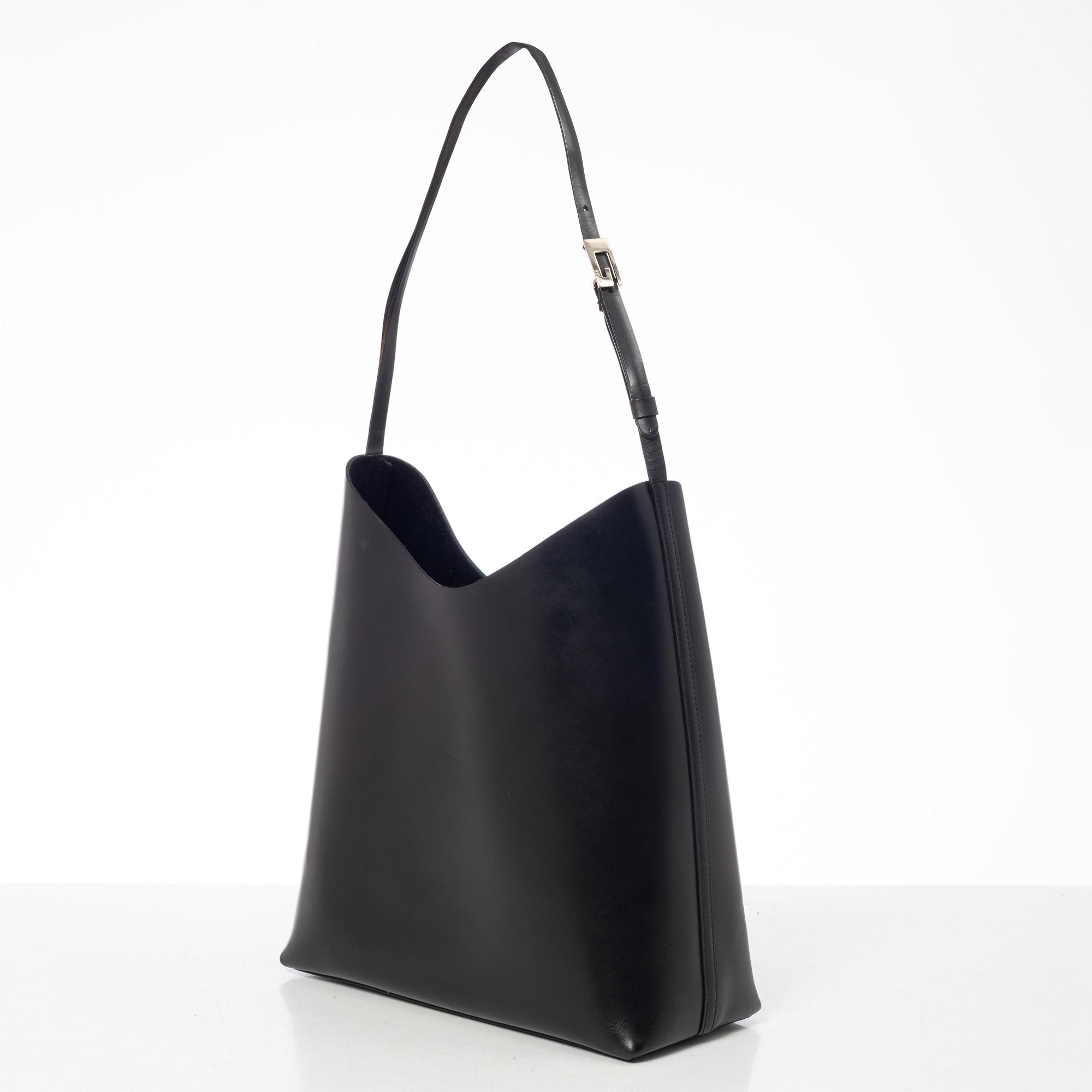 Gucci, A black leather bag.