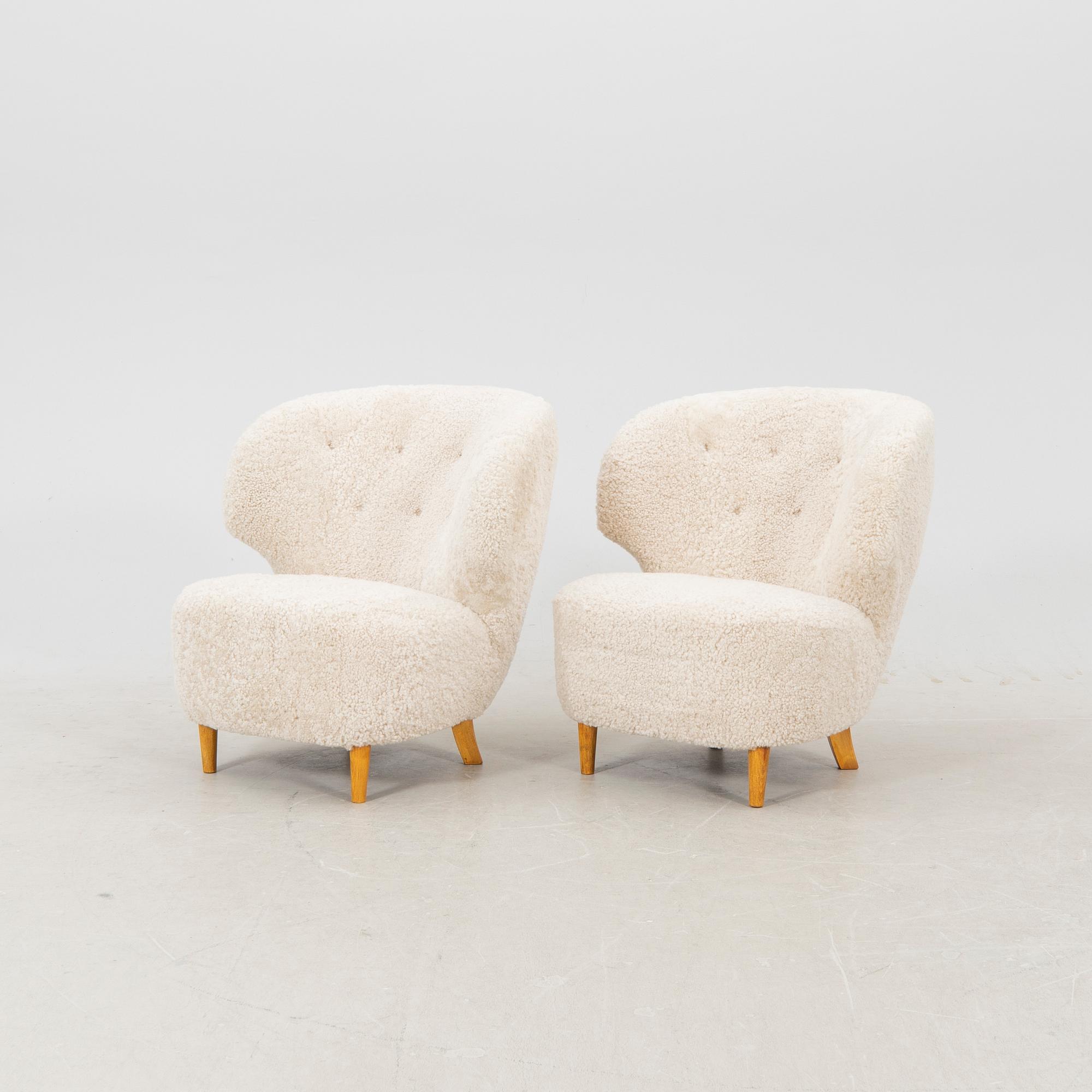 A pair of Scandinavian Modern 1940s cheepskin armchairs.