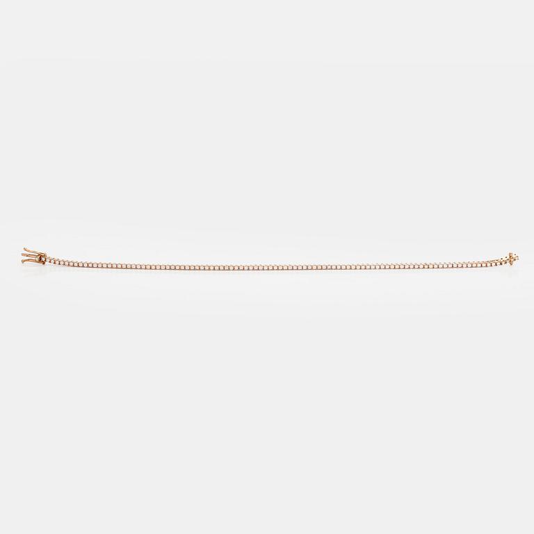An 18K rose gold tennis bracelet with brilliant cut diamonds.