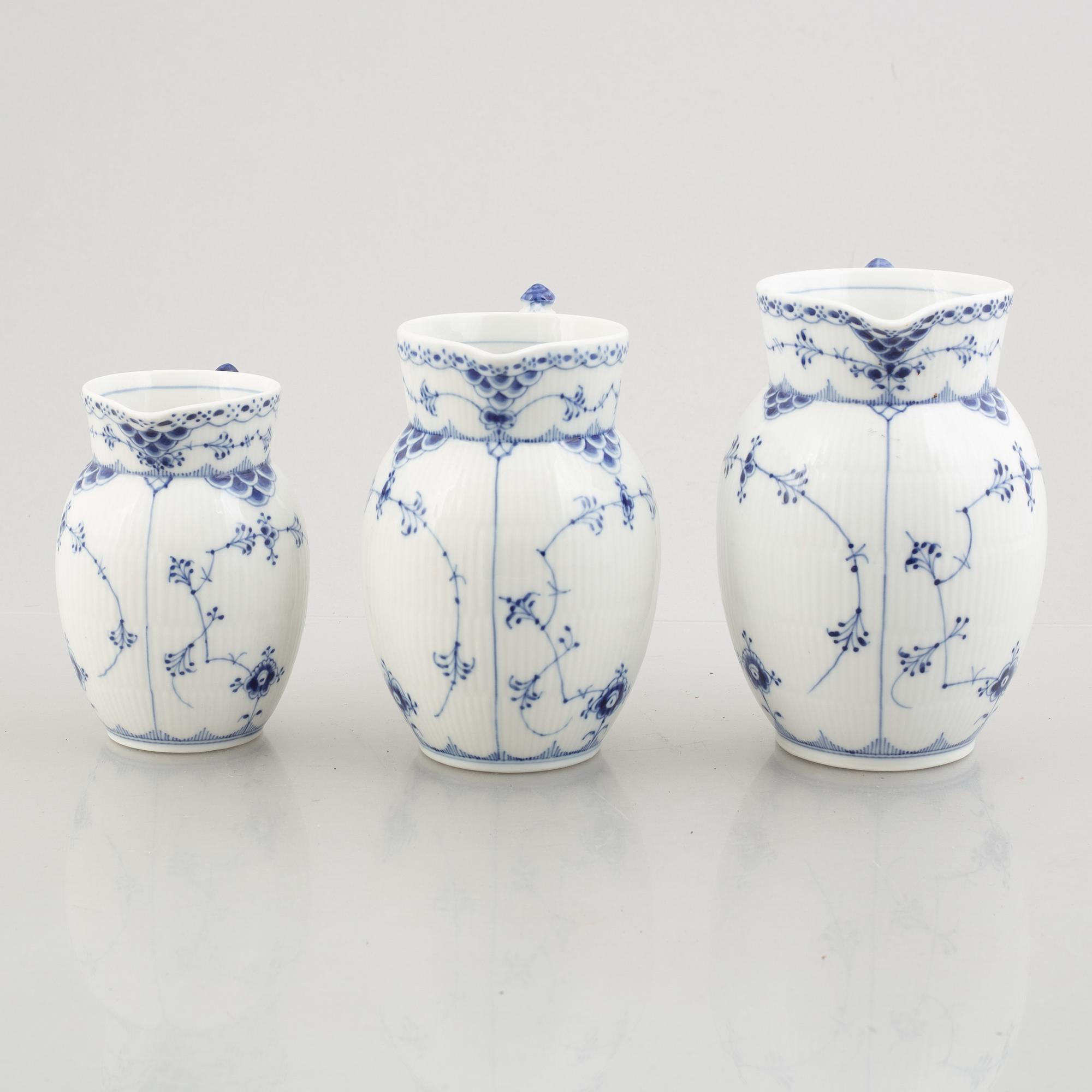 Three 'Blue Fluted Half Lace' / 'Musselmalet' porcelain jugs, Royal Copenhagen, model 562, 561, 763, 1898-1923 and 1962.