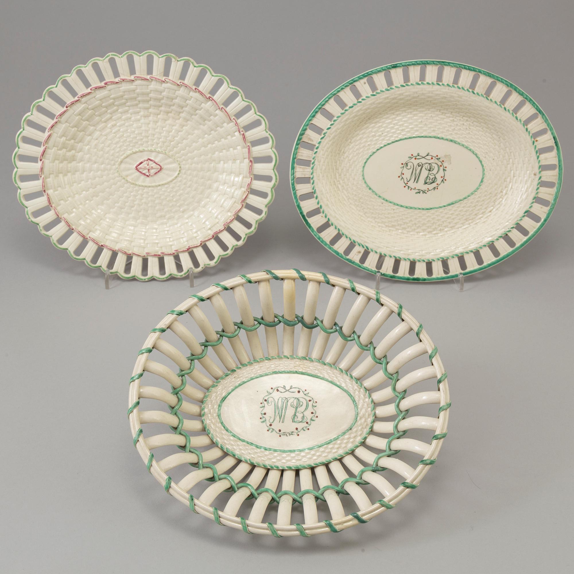 A CREAMWARE BASKET, PLATE AND A SIMILAR PLATE, one marked Wedgwood, first half of the 19th century.