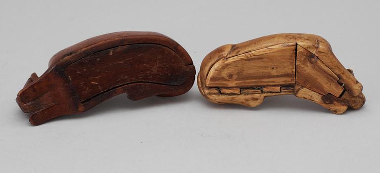 Two 19th-20th century birch snuffboxes in the shape of lying dogs.
