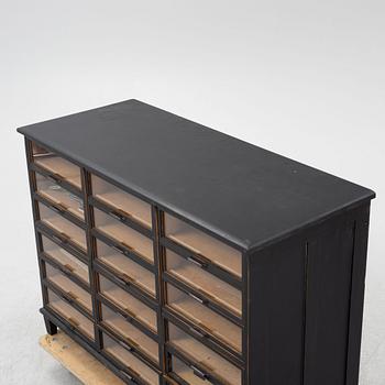 A painted desk with drawers with glass fronts.