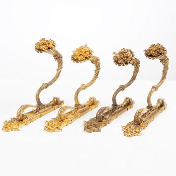 A set of four gilt bronze Louis XVI-style curtain holders, late 19th century.