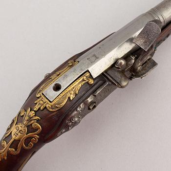 Two percussion and a flintlock pistol, 18th and 19th Century.