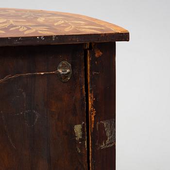 A 19th century corner cabinet.