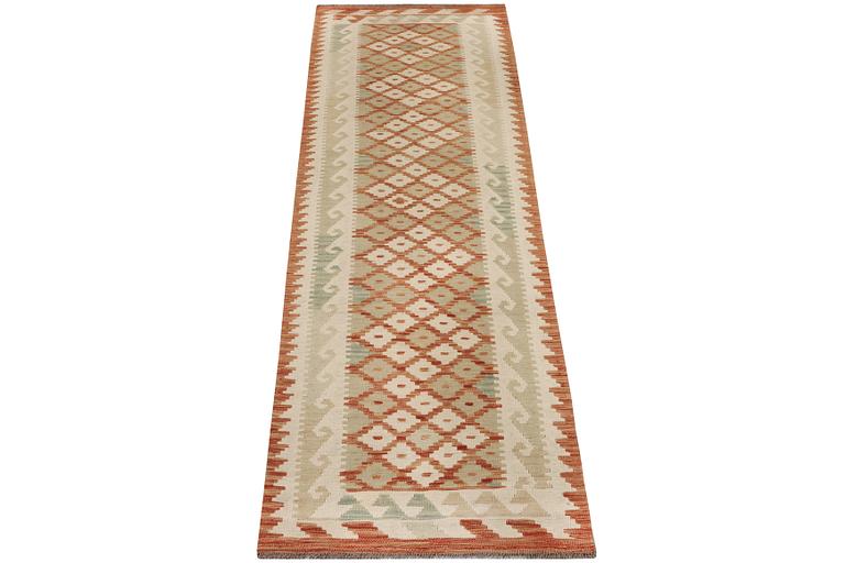 An Afghan kilim runner, c. 296 x 78 cm.