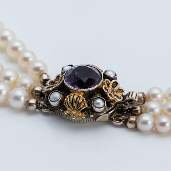 A cultured saltwater pearl collier with silver lock with purple faceted amethyst.