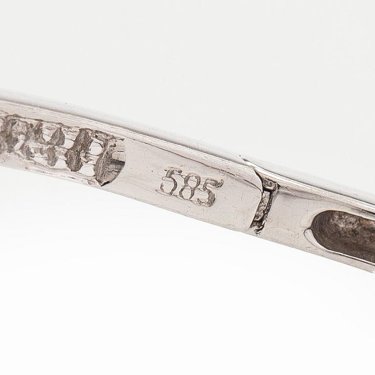 A pair of 14K white gold  hoop earrings with diamonds.