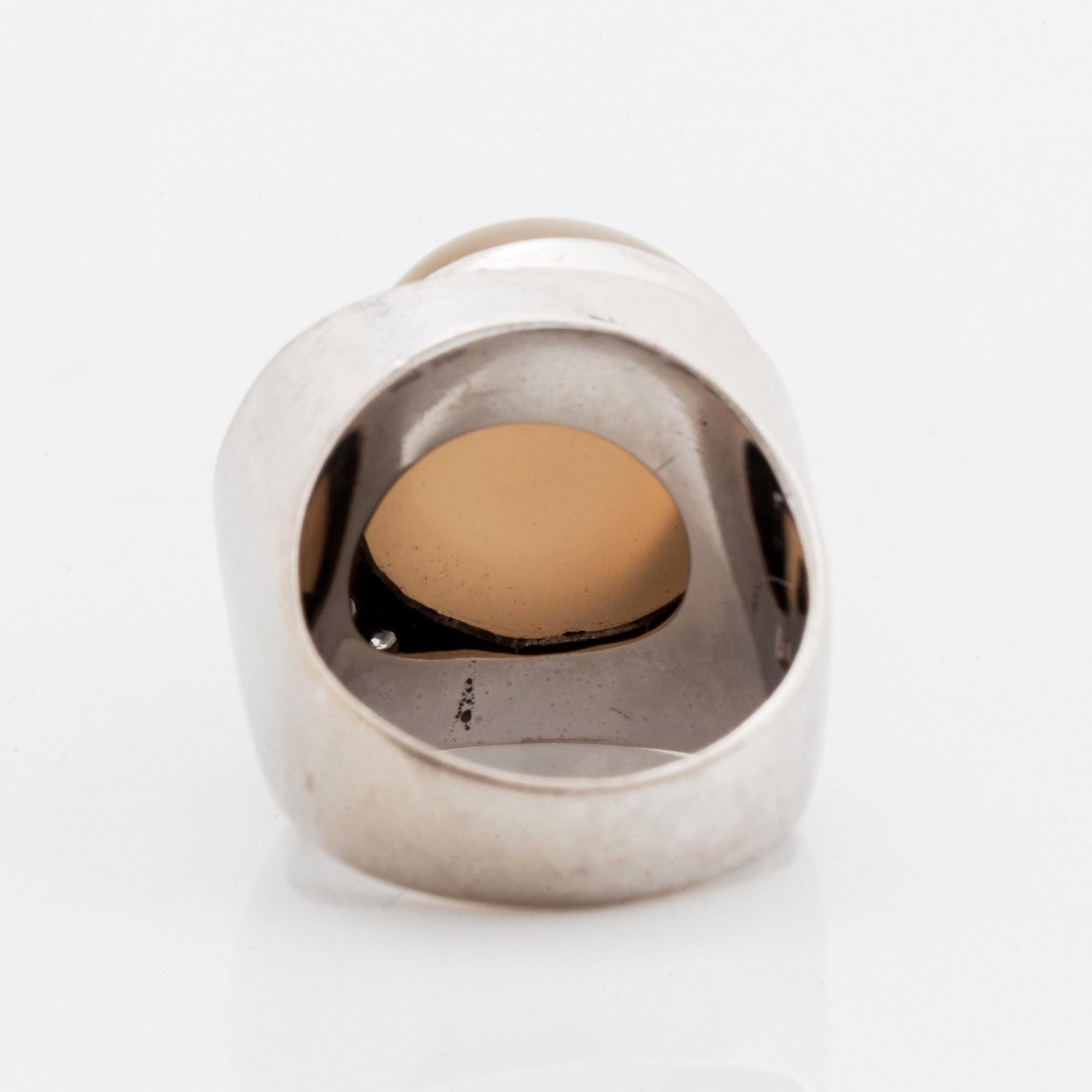 Ring 18K vitguld med en cabochonslipad månsten och runda briljantslipade diamanter.