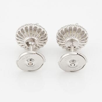 A pair of 18K gold earrings with round brilliant-cut diamonds.