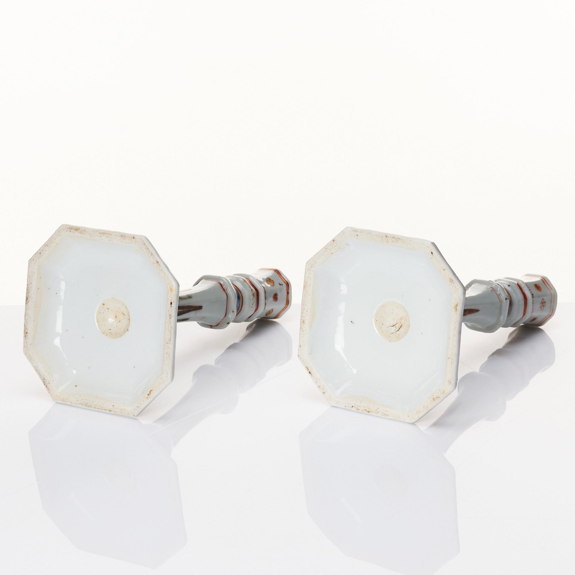 A pair of famille rose candles sticks, Qing dynasty, Qianlong (1736-95).