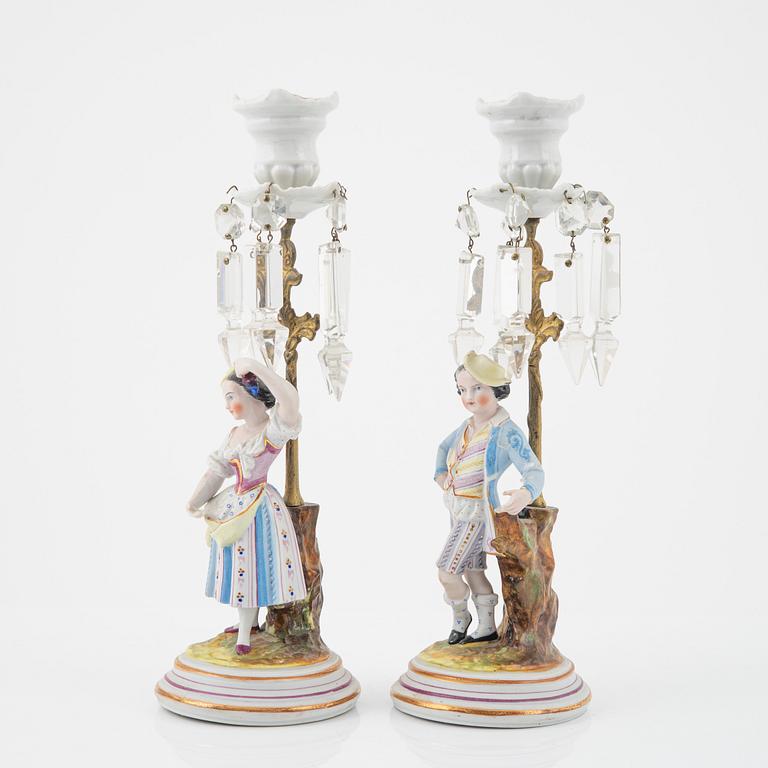 A pair of porcelain Rococo style candlesticks, late 19th Century.