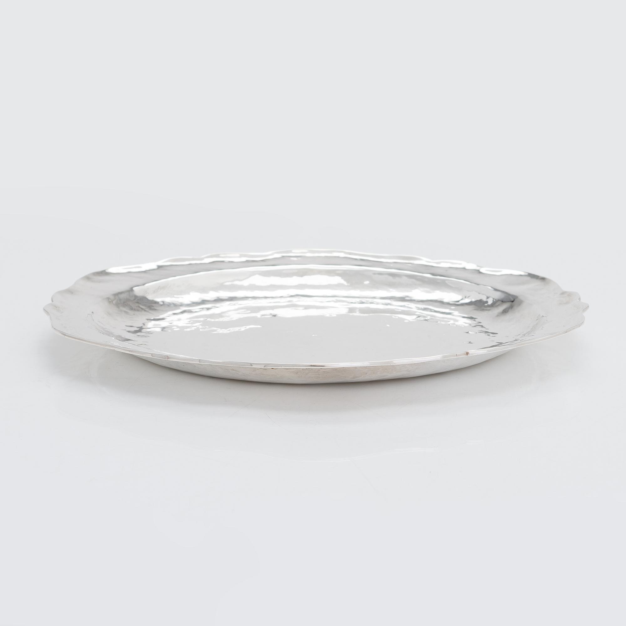 A 12-piece set of sterling silver chargers, Peru 1950s-60s.