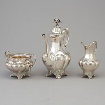 A three piece silver coffee set dated 1916-17.