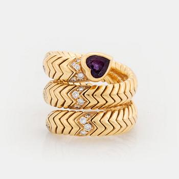 A Bulgari "Spiga" 18K gold ring set with an amethyst and round brilliant-cut diamonds.