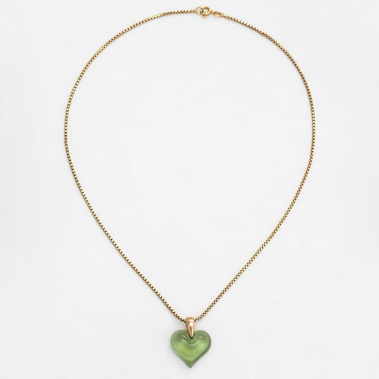 A Lalique heart pendant with an 18K gold chain.