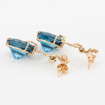 Earrings with blue topazes and brilliant-cut diamonds.