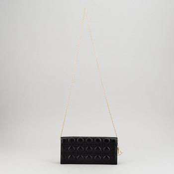 Christian Dior, a quilted leather handbag/clutch.
