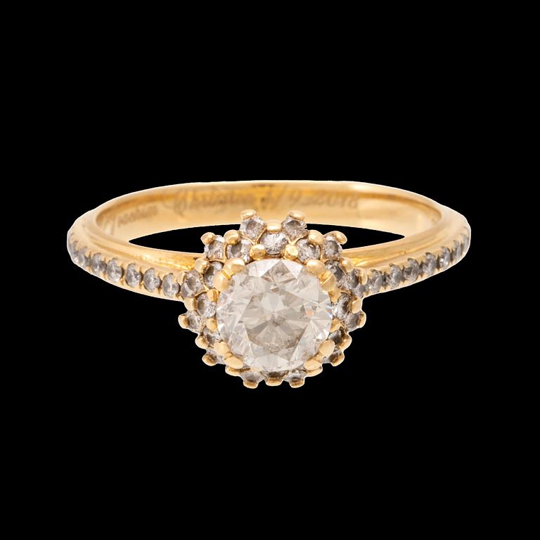 An 18K gold ring set with round brilliant-cut diamonds.