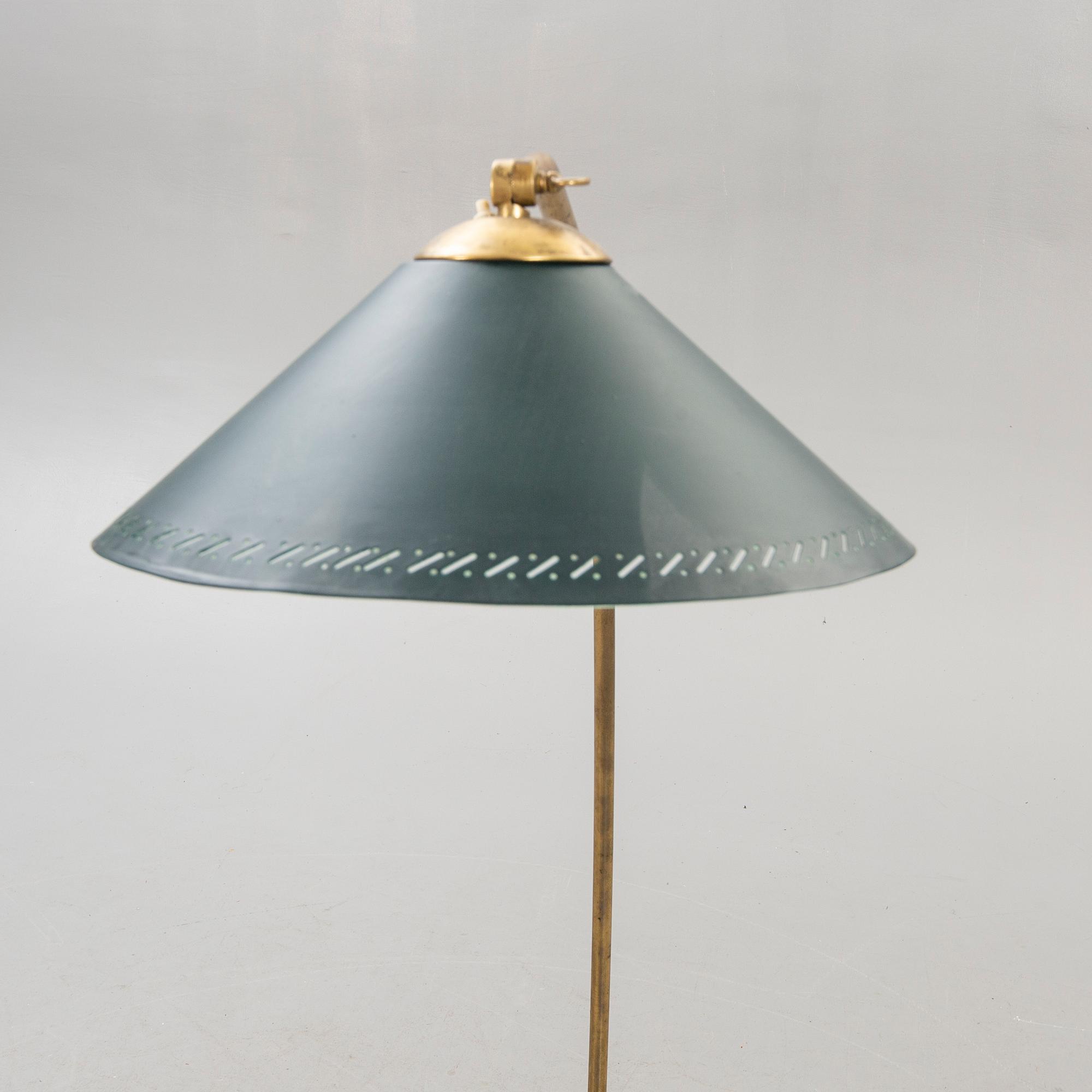 A 1950s brass floor lamp.