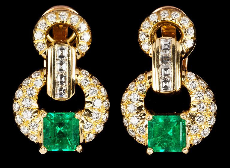 A pair of emerald and diamond earrings.