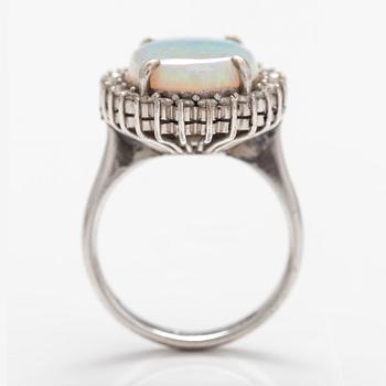 A 14K white gold ring with a probably real opal and diamonds ca. 0.65 ct in total.